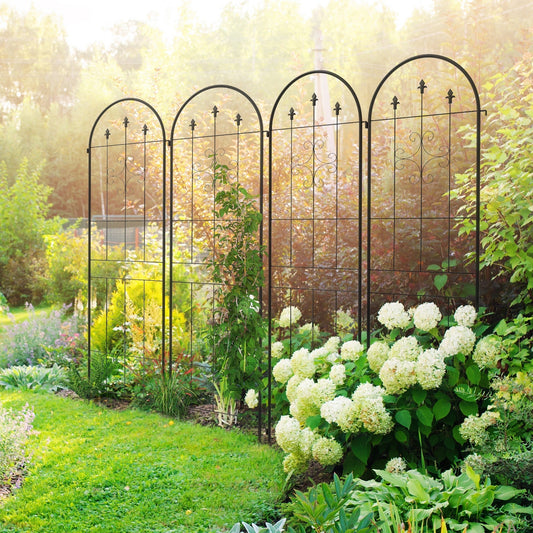 Four spiral anchor garden trellis panels in a lush garden with climbing plants