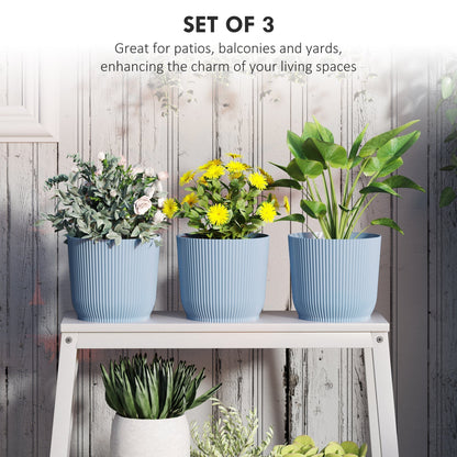 Three blue ribbed planters with different plants on a shelf