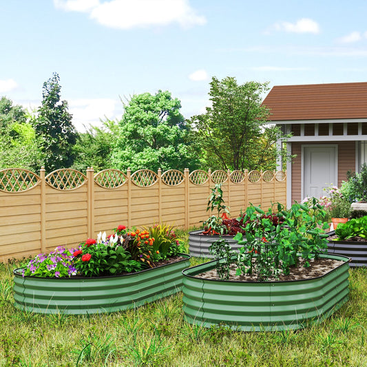 Two green steel garden beds filled with flowers and vegetables in a garden setting