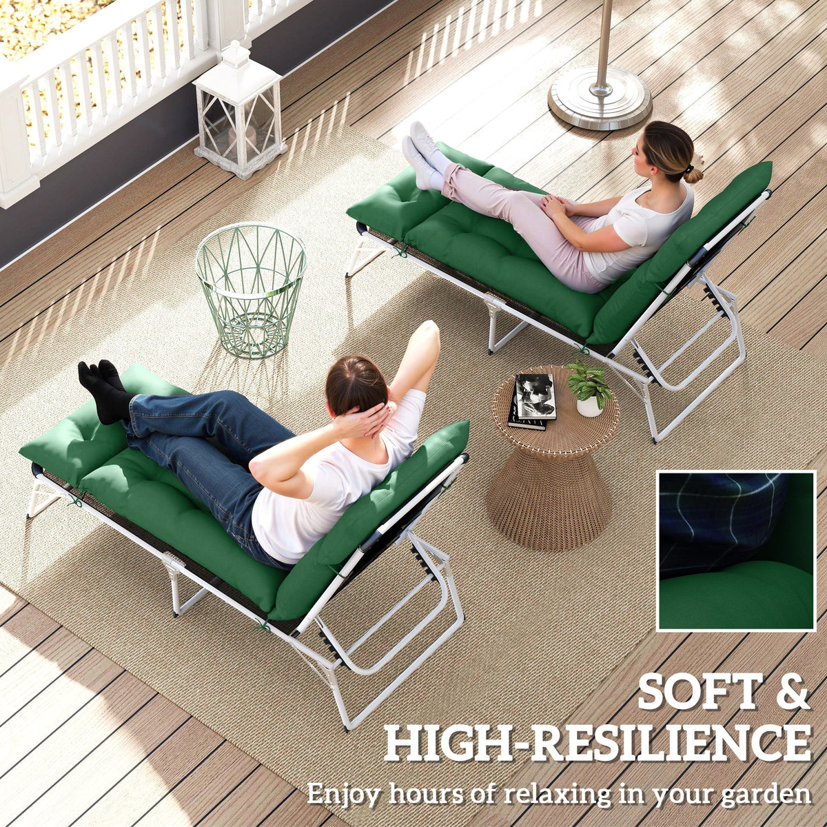 Two people relaxing on sun loungers with green cushions on a patio