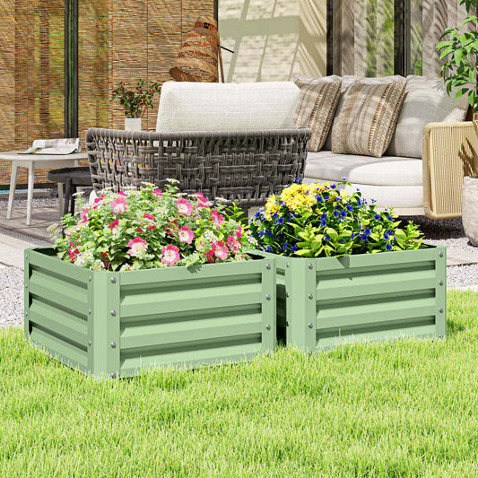 The garden planters filled with colourful flowers sitting on a green lawn in a patio setting
