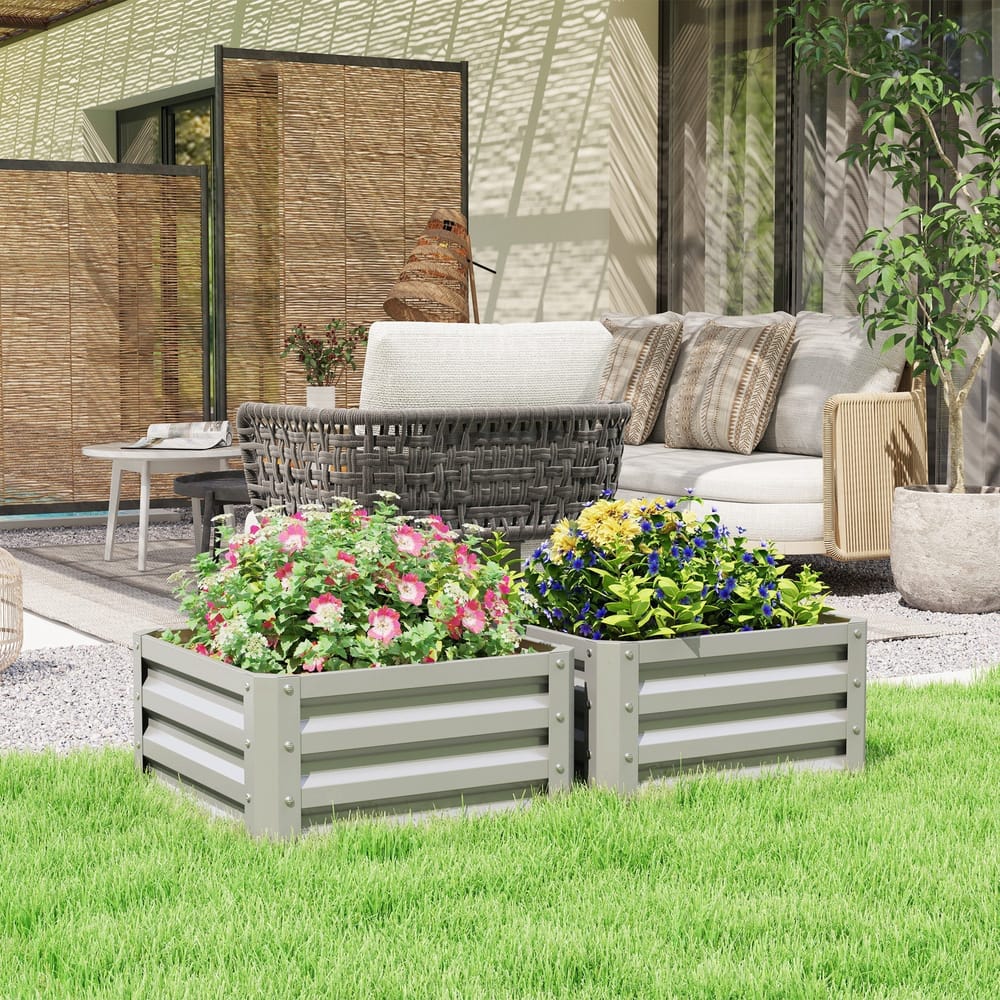 The steel planter boxes placed on a green lawn in a patio area with outdoor furniture