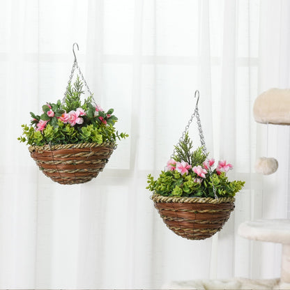 Two artificial flower baskets hanging indoors near a window and a cat tree