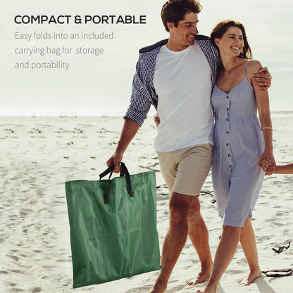 Couple carrying a green metal frame beach chair in a carry bag on the beach