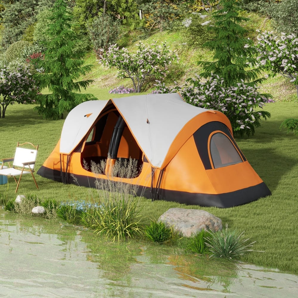 The family camping tent set up on grass next to a body of water
