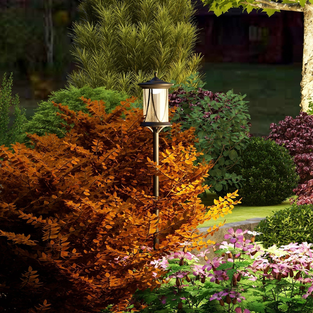 The garden lighting lamp post standing amongst colourful bushes and flowers at dusk