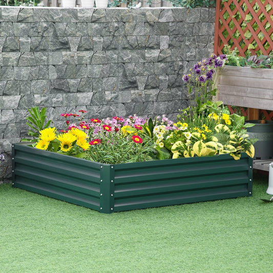 The dark green raised garden bed box filled with colourful flowers and green plants