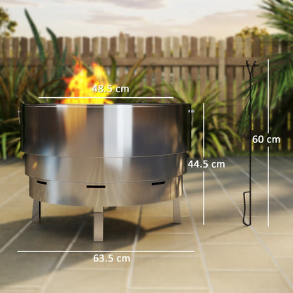The metal fire pit with a fire burning inside and a poker standing next to it