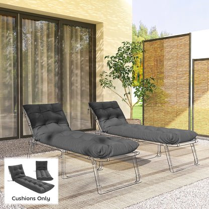 Two dark grey garden lounge chair cushions placed on sun loungers on a patio