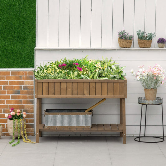 Wooden herb planter filled with plants and flowers on a patio