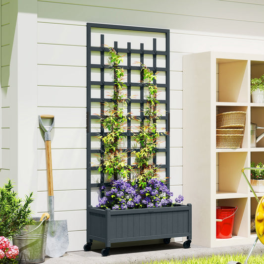 The grey wooden planter with trellis is shown against a white wall with plants growing up it