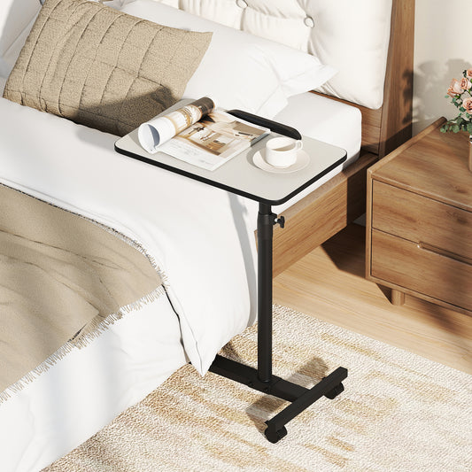 The bedside table is placed next to a bed with a magazine and cup on top