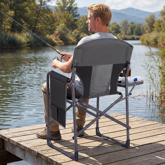 The camping chair with side table in use by a man fishing on a wooden jetty