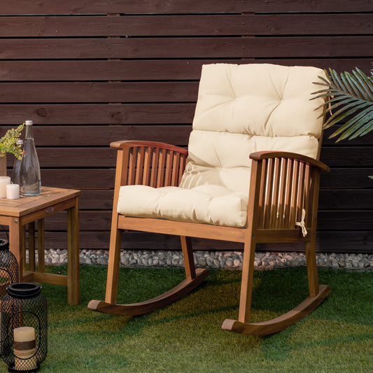 The outdoor cushion placed on a wooden rocking chair in a garden setting against a fence
