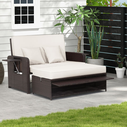 The patio furniture set is shown assembled on a paved patio area next to a white wall and green grass