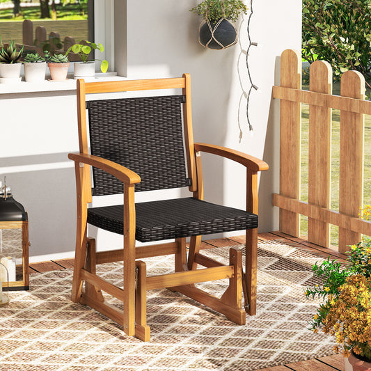 The patio rocking chair on a wooden deck with plants and a fence
