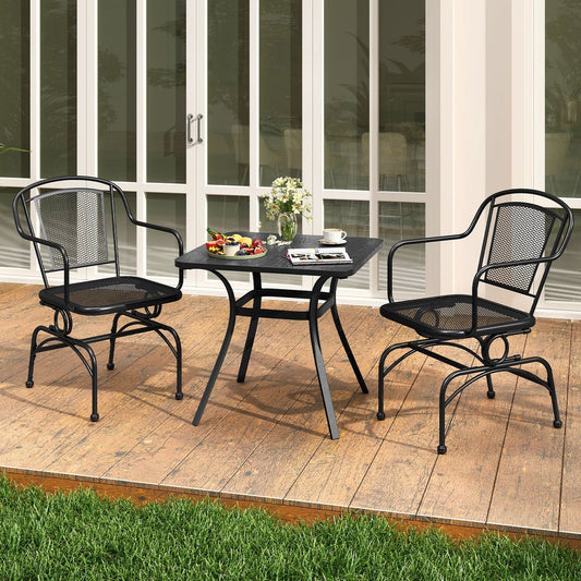 Two black metal rocking chairs and a small square table on a wooden patio