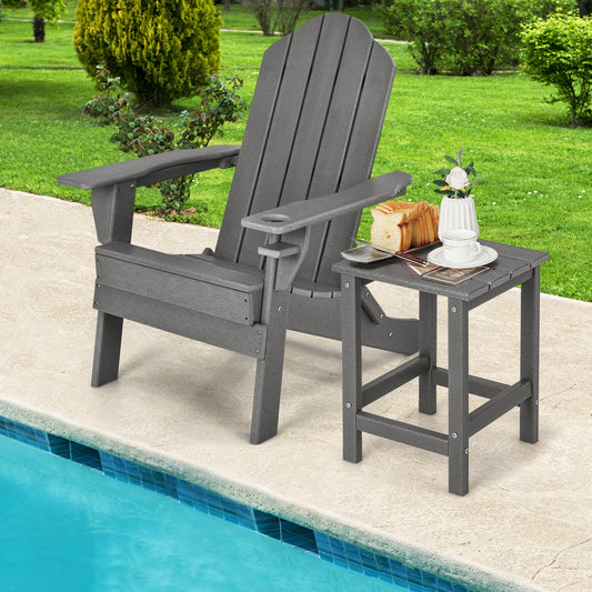 The grey patio table sits next to a large chair by a swimming pool