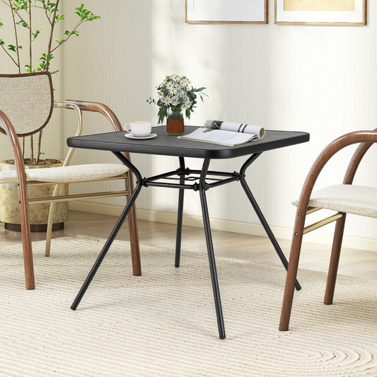 The square outdoor dining table set up with chairs in a room