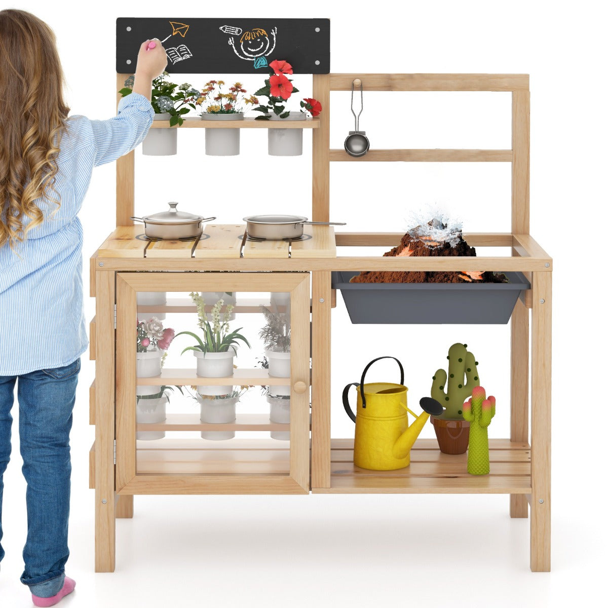 A child drawing on the chalkboard of the play kitchen set while standing on a white background