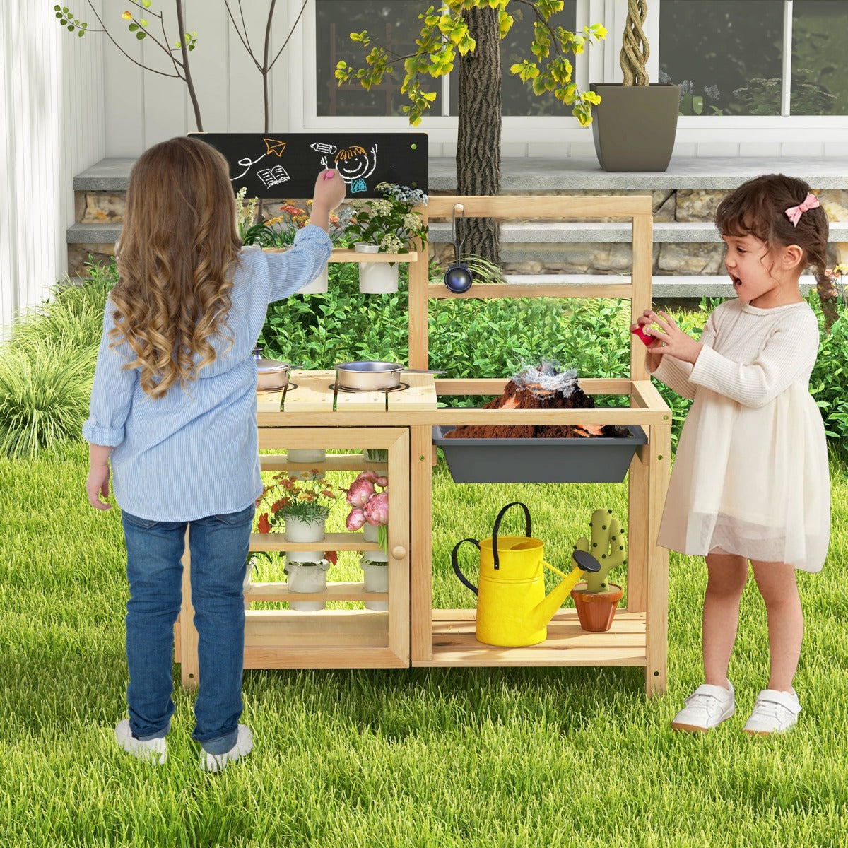 Two young girls playing with the play kitchen set outdoors on a sunny day in the garden