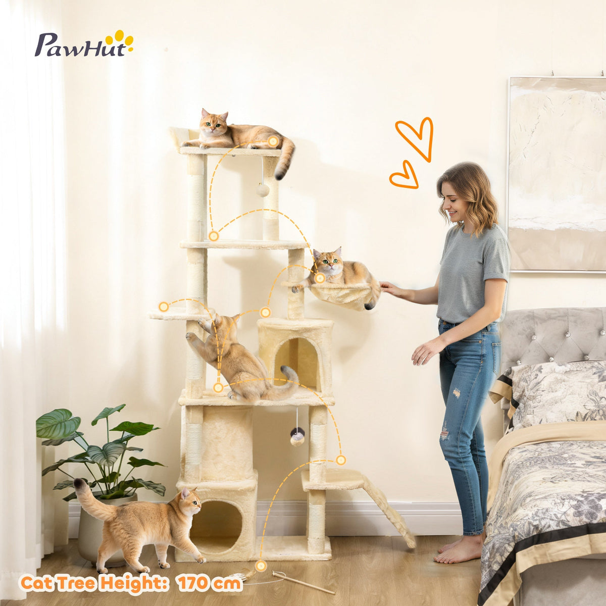 The large cat tree in a room with cats playing on its platforms, condos and scratching posts