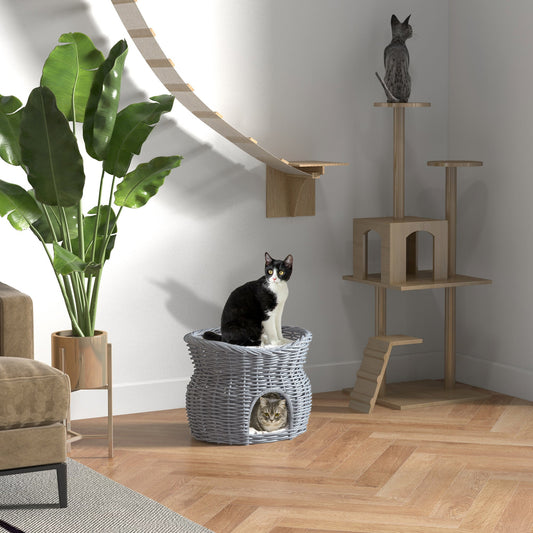 The grey wicker cat house is shown in a room with two cats, one on top and one inside