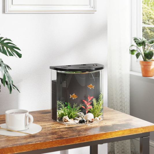 The small fish tank with filter system on a wooden table with two goldfish swimming inside