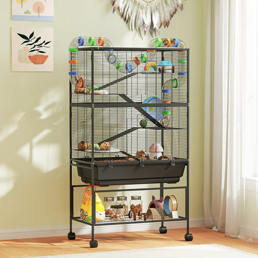 Large hamster cage with accessories and food on the floor in a room