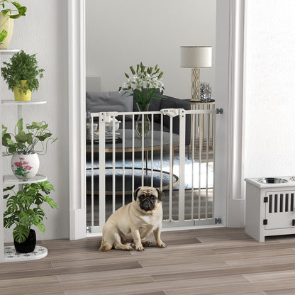 The white dog gate is installed in a doorway with a pug sitting in front of it