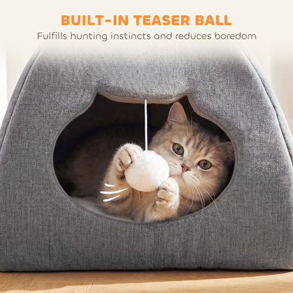 A kitten playing with the built-in teaser ball inside the grey cat cave bed