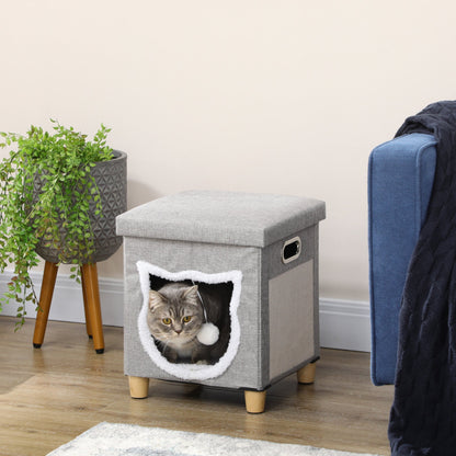 A grey cat bed cube with a scratching pad on the side, shown with a cat inside