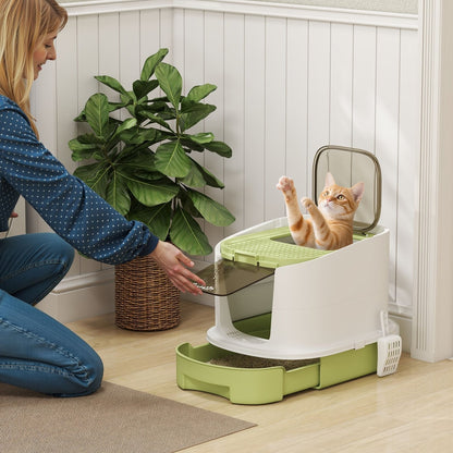 A woman and a cat interacting with the top entry litter box in a domestic setting