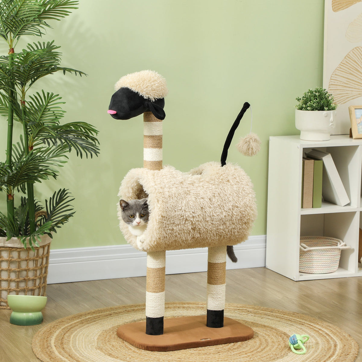 A grey cat sits inside the tunnel of the sheep design cat tree in a room setting