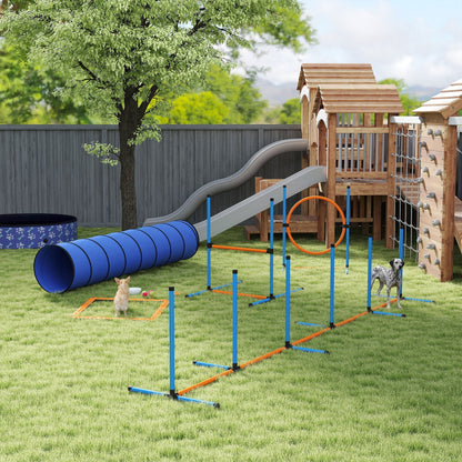 The dog agility training set in use in a garden with two dogs jumping through the tunnel and over hurdles