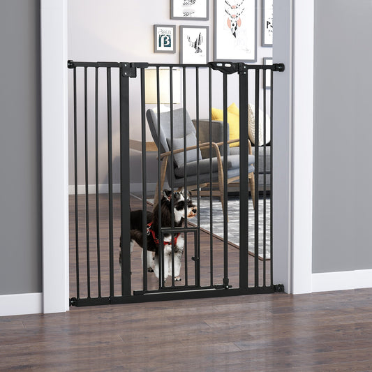 The dog gate installed in a doorway with a small dog standing behind it