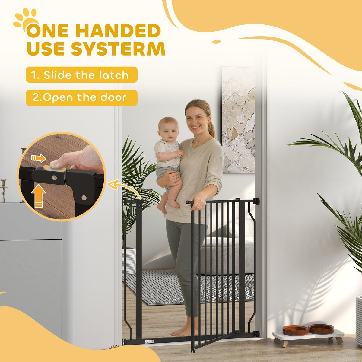 The dog gate being opened by a woman holding a baby to show the one handed latch system