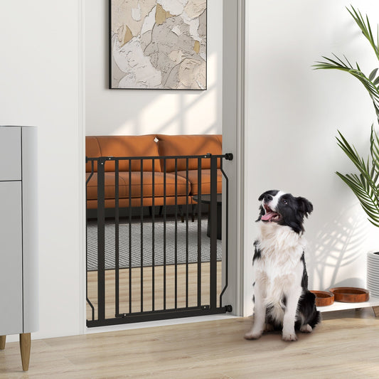 The dog gate installed in a doorway with a dog sitting on the floor in front of it