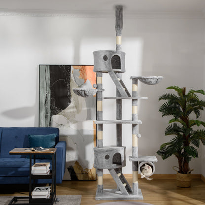 The floor to ceiling cat tree in a living room with a cat inside