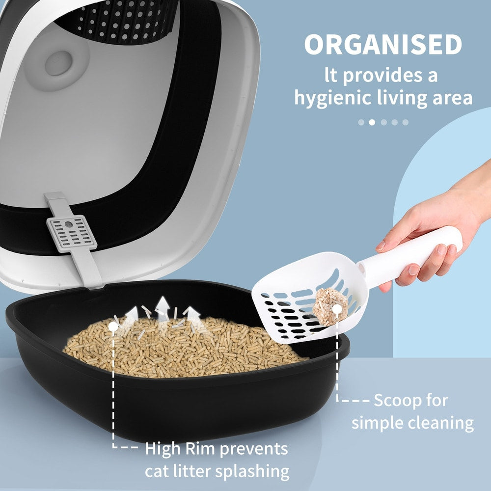 The black litter tray with high rim and a scoop filled with litter