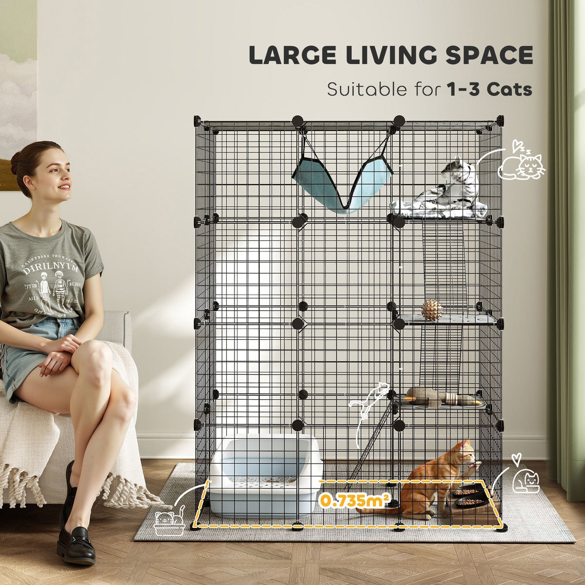 A woman sitting next to a spacious black wire cat cage, highlighting its large living space