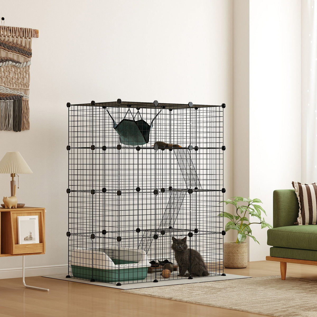 A black wire cat house with a cat inside, showing the ramps and hammock