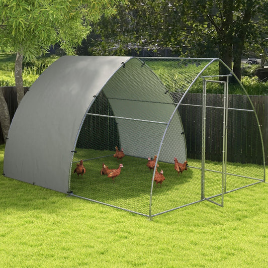 The outdoor chicken coop set up on a lawn with several chickens inside