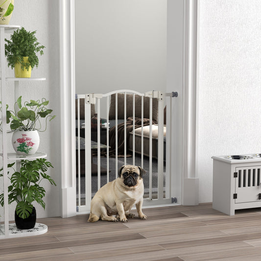 The adjustable dog gate is installed in a doorway with a pug sitting in front of it