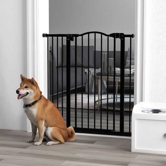 The black metal dog gate is installed in a doorway, with a Shiba Inu dog sitting in front of it