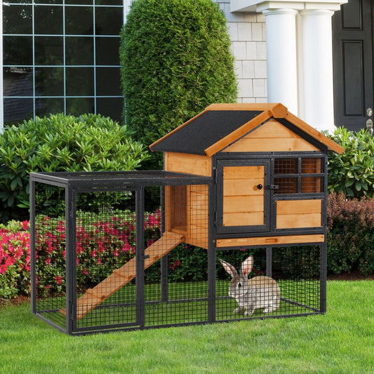 This wooden and metal rabbit hutch is shown in a garden with a rabbit inside the run area