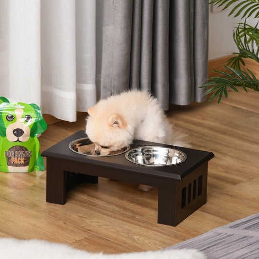 A small fluffy dog eating from the raised dog feeding bowls with stand in a room setting