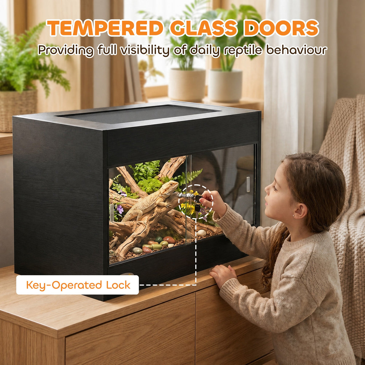 Child opening the tempered glass doors of the reptile vivarium