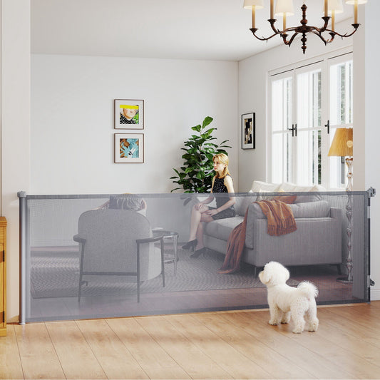 The pet gate installed in a living room with a small dog standing in front of the mesh barrier