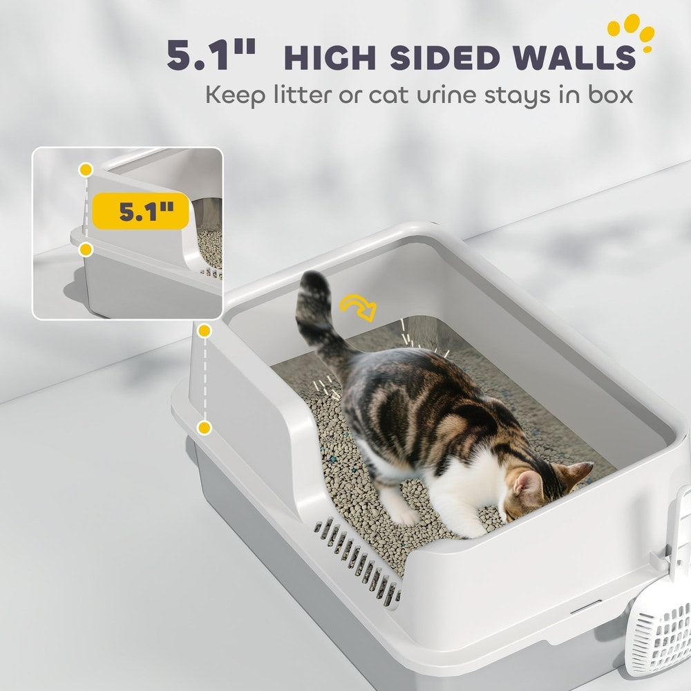 A cat walks inside the litter box with high sided walls to keep litter contained